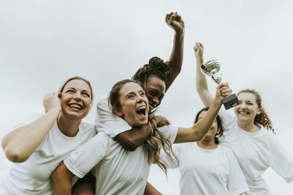 Female football players celebrating their victory as part of the aftercare program at Saving My Tomorrow