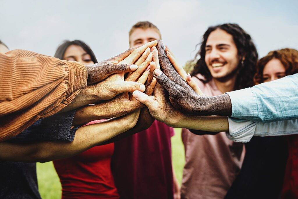 People joining hands to show community support against addiction