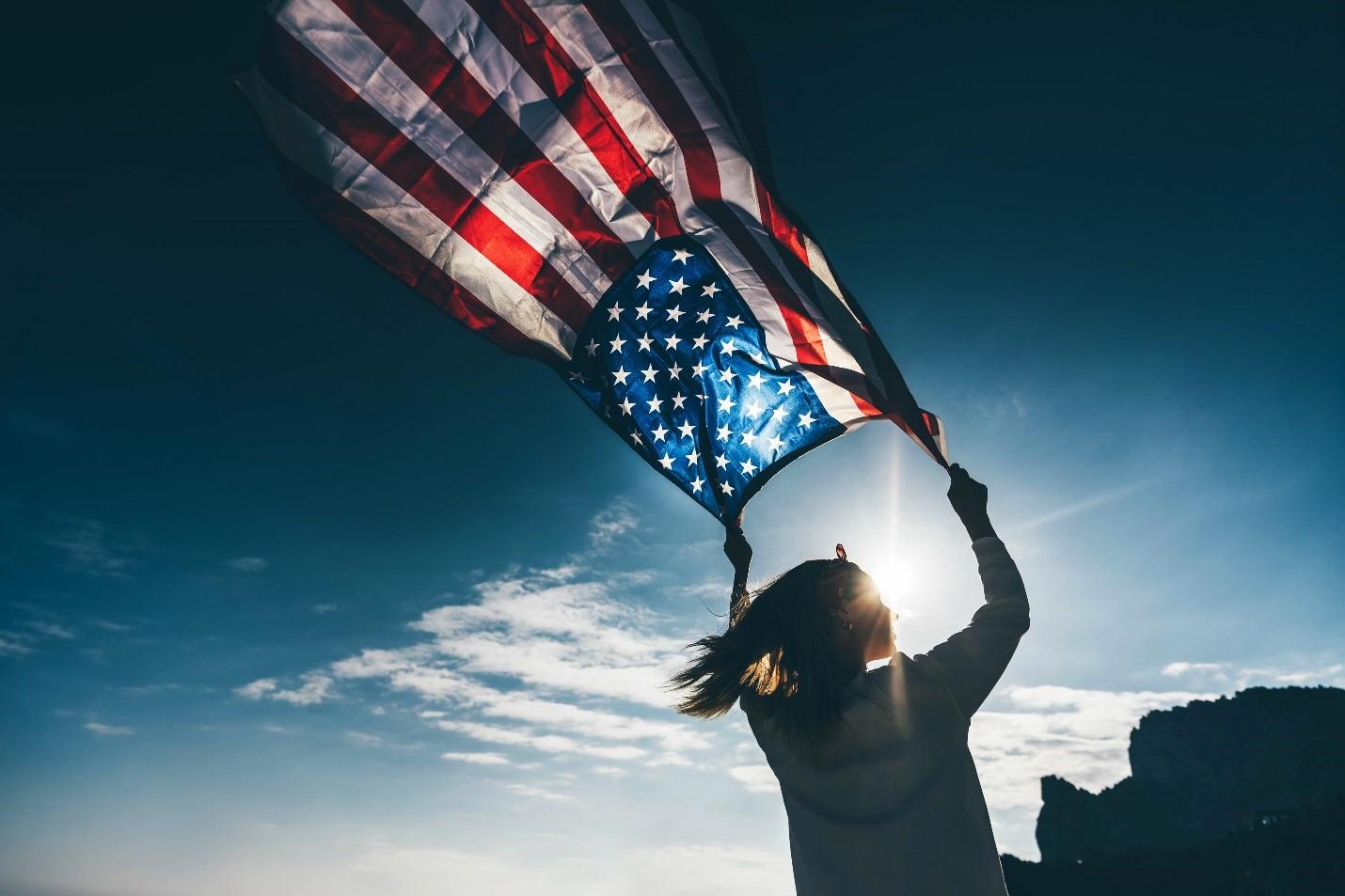 A woman running with the American flag, celebrating a sober 4th of July