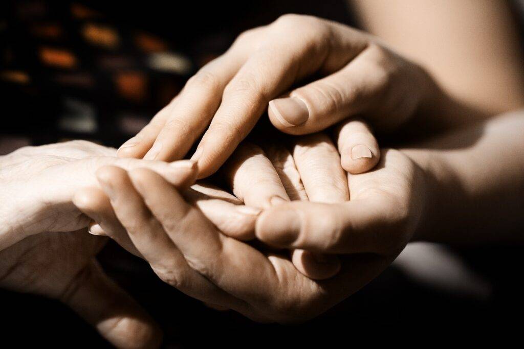 Hands clasping each other in comfort as part of an aftercare program at Saving My Tomorrow