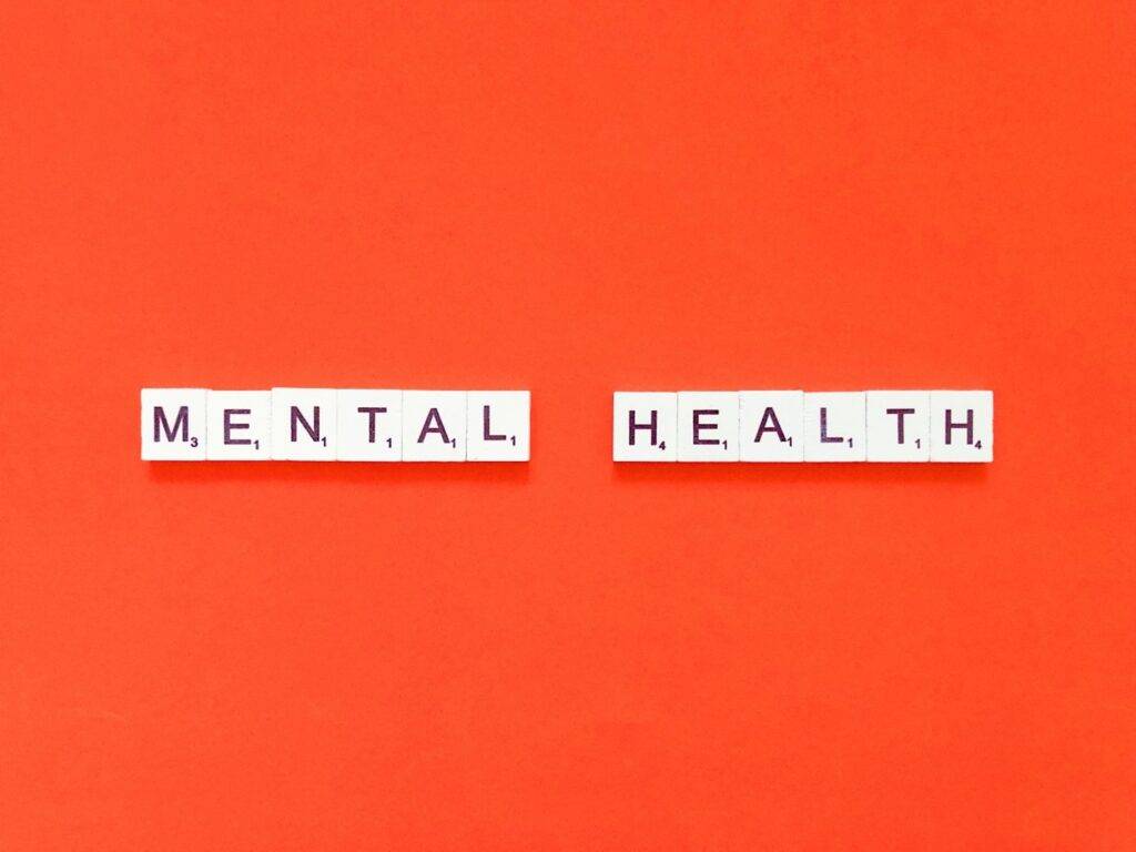 "Mental Health" spelled out in block letters against a red background, symbolizing a dual diagnosis