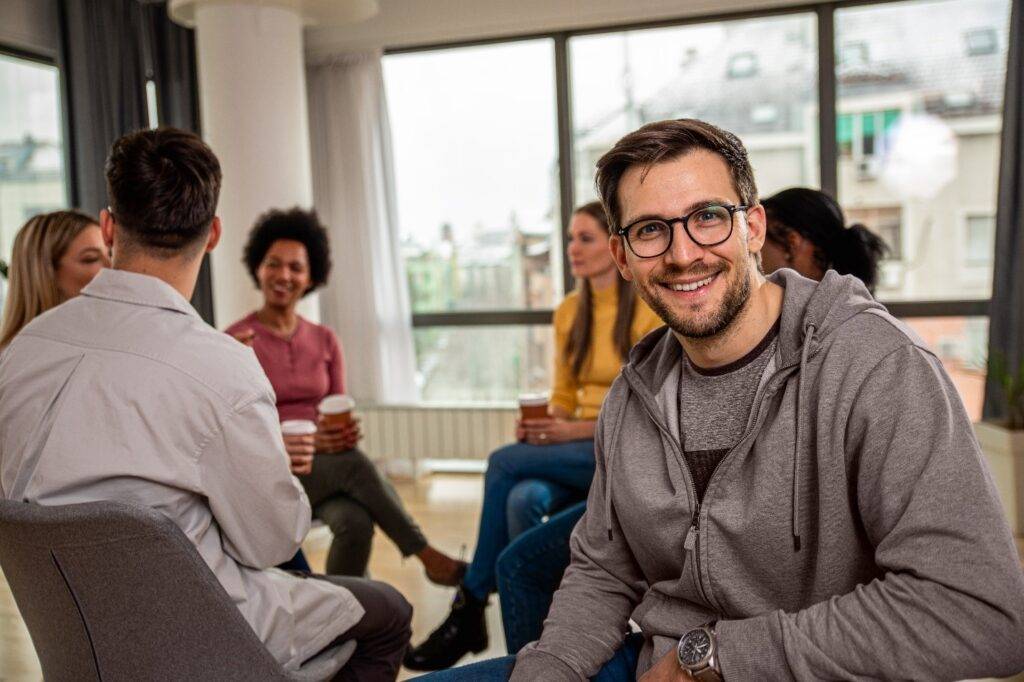 A man in a support group looking at us after completing detox