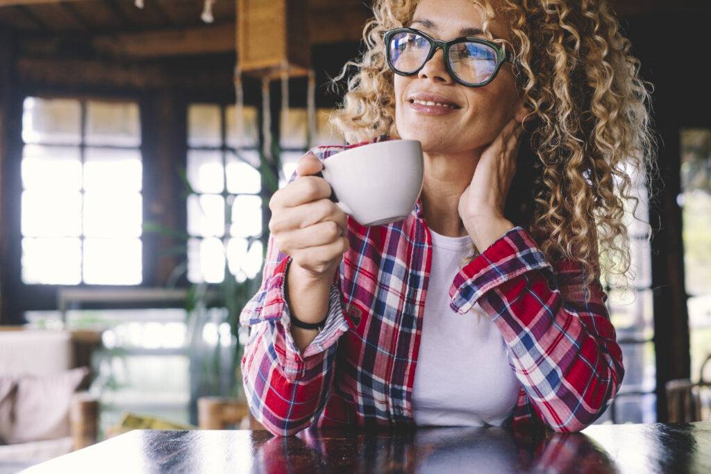 Middle aged woman drinking coffee after her addiction recovery